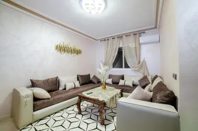 a living room with a couch and a table at Charming and quiet apartment 1 in Marrakech