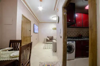 a kitchen and living room with a washing machine at Charming and quiet apartment 1 in Marrakech
