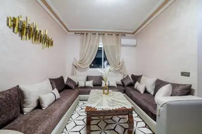 a living room with a couch and a table at Charming and quiet apartment 1 in Marrakech