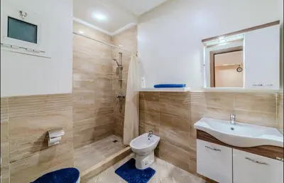 a bathroom with a white sink and a toilet at Appartement cosy moderne piscine in Marrakech