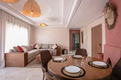 a living room with a table and a couch at The Medina Touch - Marrakech in Marrakech