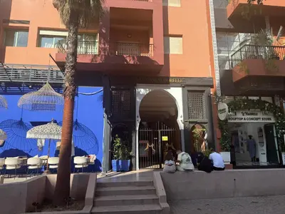 a group of people sitting in front of a building at Chez Houda in Marrakech
