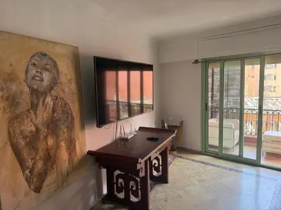 a room with a large painting of a woman on the wall at Chez Houda in Marrakech