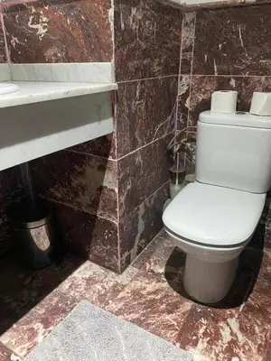 a bathroom with a white toilet and a sink at Chez Houda in Marrakech