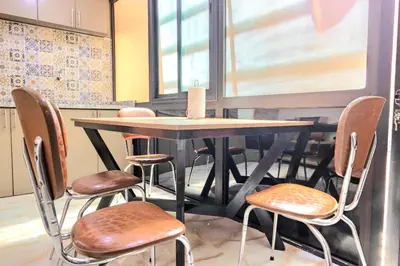 a table and four chairs in a kitchen at Residence Jnan Atlas gueliz in Marrakech
