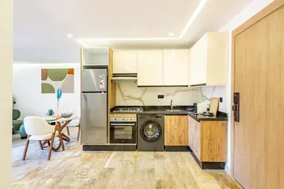 a kitchen with a refrigerator and a dishwasher at Stylish modern 1BR in gueliz in Marrakech