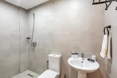 a bathroom with a toilet and a sink at 5 Stars Home with Pool & Parking in Marrakech