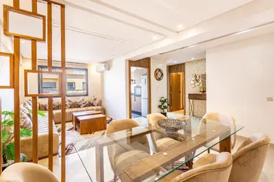 a dining room with a glass table and chairs at 5 Stars Home with Pool & Parking in Marrakech