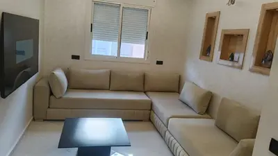 a living room with a couch and a table at appartement moderne marrakech in Marrakech
