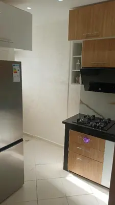a kitchen with a stove and a refrigerator at marrakech premium village c18 in Marrakech