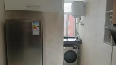 a kitchen with a refrigerator and a washing machine at marrakech premium village c18 in Marrakech