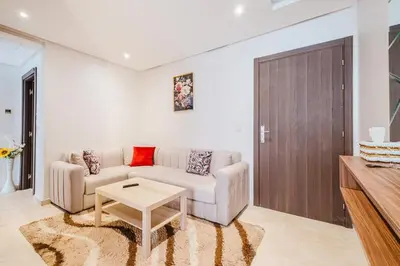a living room with a couch and a table at Luxe 2-Bedroom with Pool in Marrakech in Marrakech