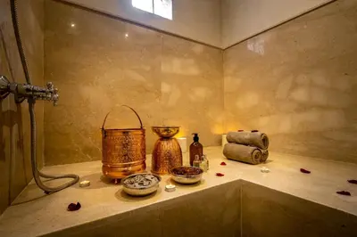 a bathroom with a shower with some items on a shelf at Riad Malaika in Marrakech