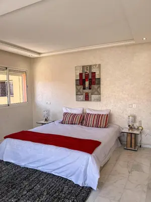 a bedroom with a large white bed with two pillows at Apartment with pool in Guéliz Hadika al koubra in Marrakech