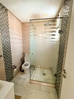 a bathroom with a glass shower with a toilet at Apartment with pool in Guéliz Hadika al koubra in Marrakech