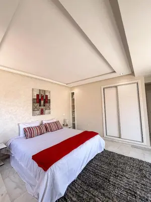a bedroom with a large bed and a large window at Apartment with pool in Guéliz Hadika al koubra in Marrakech
