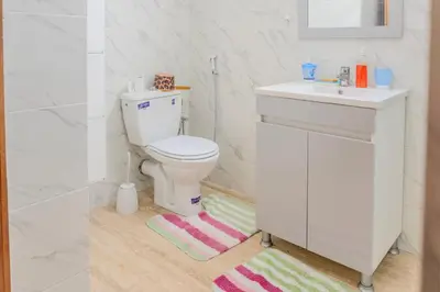 a bathroom with a white toilet and a sink at Chic & spacious apartment in Gueliz in Marrakech