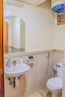 a bathroom with a sink and a toilet and a mirror at Chic & spacious apartment in Gueliz in Marrakech