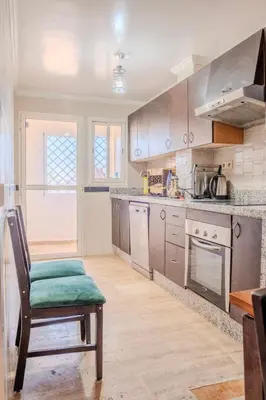 a kitchen with a table and a chair in it at Chic & spacious apartment in Gueliz in Marrakech