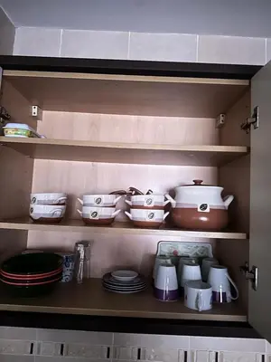 a kitchen shelf with dishes and bowls and plates at Gueliz -La Kasbah AC oneBedroom Apart with parking in Marrakech