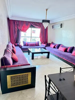 a living room with purple couches and a table at Gueliz -La Kasbah AC oneBedroom Apart with parking in Marrakech