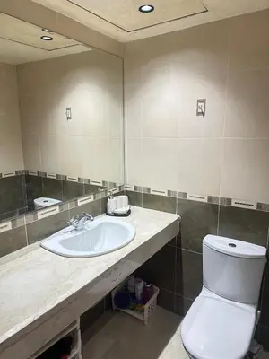 a bathroom with a sink and a toilet and a mirror at Gueliz -La Kasbah AC oneBedroom Apart with parking in Marrakech