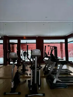 a gym with several treadmills and elliptical machines at Gueliz -La Kasbah AC oneBedroom Apart with parking in Marrakech