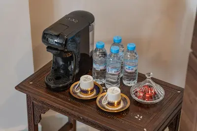 a coffee maker sitting on a table with bottles of water at Appartement in Marrakech in Marrakech