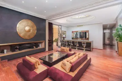 a living room with a couch and a fireplace at Domaine Marradise in Marrakech