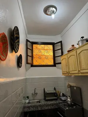a kitchen with a sink and a window at Logment cosy in Marrakech