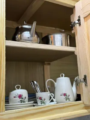 a cabinet with two tea cups and a pot at Logment cosy in Marrakech