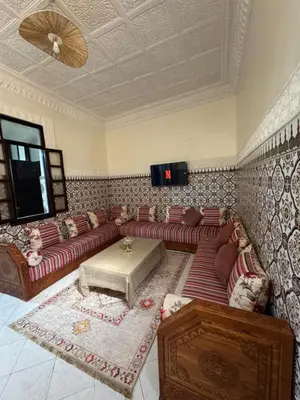 a living room with a couch and a table at Logment cosy in Marrakech