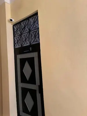 a black door in the corner of a building at Logment cosy in Marrakech