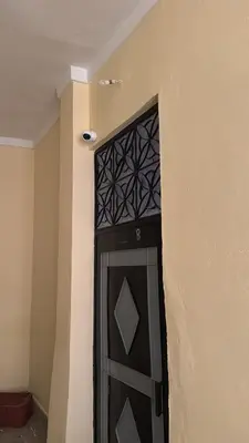 a black door in the corner of a building at Logment cosy in Marrakech