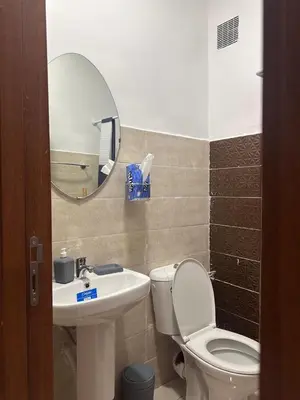a bathroom with a toilet and a sink and a mirror at Dar al Montazah in Marrakech