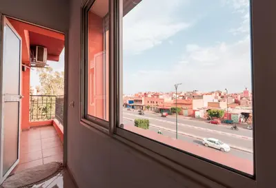 a window with a view of a city street at La maison du soleil in Oulad Akkou