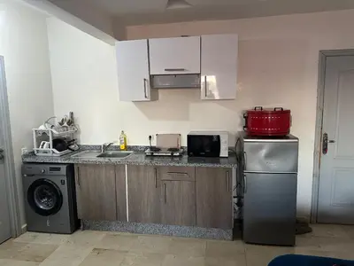 a kitchen with a sink and a dishwasher at Bright & comfortable apartment in Marrakech