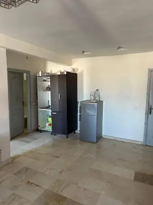 an empty kitchen with two refrigerators in a room at Bright & comfortable apartment in Marrakech