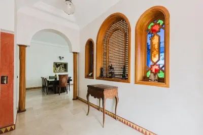 a hallway with a table and a stained glass window at Dar Saada Private Villa in Marrakech