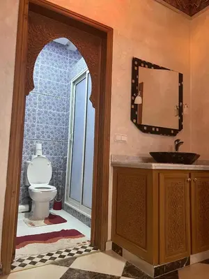 a bathroom with a sink and a toilet at Dar Hanane in El Gouassem