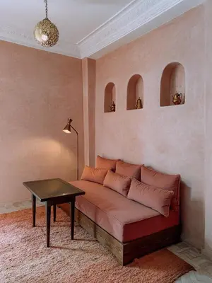 a couch sitting in a room with a table at Amanar Marrakech Boutique Hotel & Riad in Marrakech