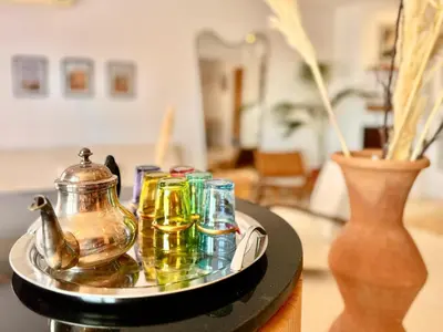 a tray with glasses and a tea kettle on a table at Elegant & Cosy Cocoon in Central Gueliz in Marrakech