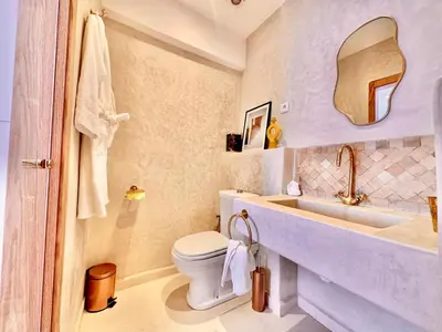 a bathroom with a toilet and a sink and a mirror at Elegant & Cosy Cocoon in Central Gueliz in Marrakech