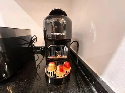 a coffee maker with donuts on top of a counter at Appartement Chic avec Terrasse à Gueliz in Marrakech