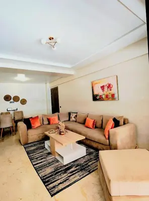 a living room with a couch and a table at Studio cosy avec piscine à Gueliz in Marrakech