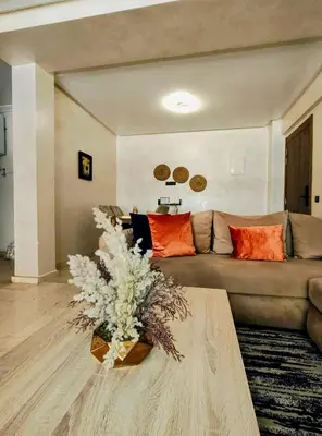 a living room with a couch and a table at Studio cosy avec piscine à Gueliz in Marrakech