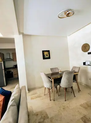 a dining room with a table and chairs at Studio cosy avec piscine à Gueliz in Marrakech