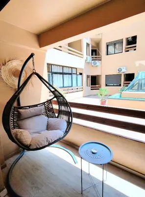 a swinging chair in a room with a balcony at Studio cosy avec piscine à Gueliz in Marrakech
