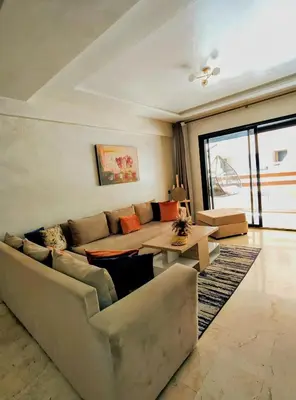 a living room with a couch and a table at Studio cosy avec piscine à Gueliz in Marrakech