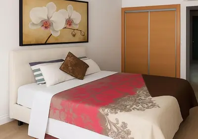 a bedroom with a white bed and a painting at Nid douillet Marrakech centre Calme et confort in Marrakech